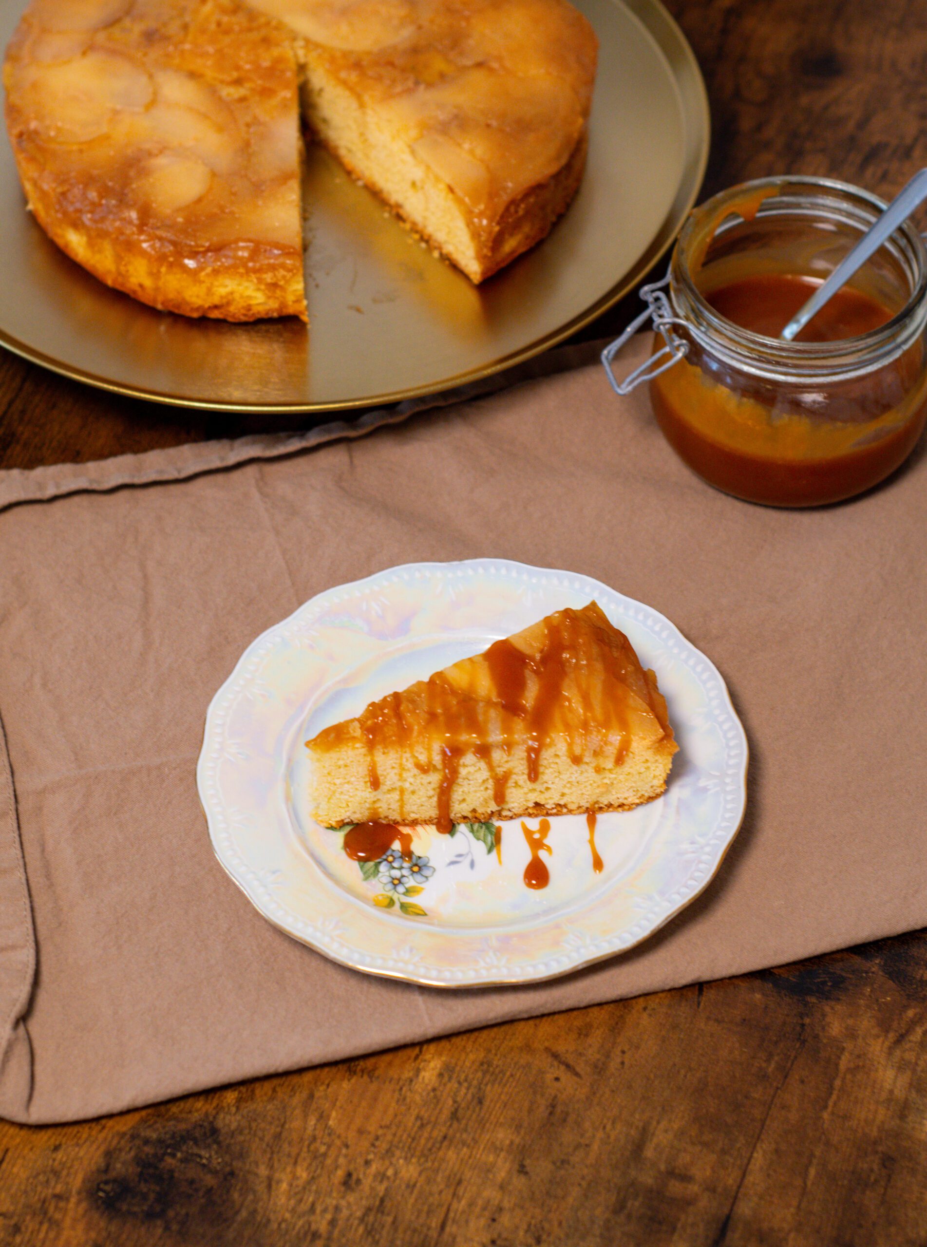 Upside down caramel pear cake with caramel topping, served on a plate